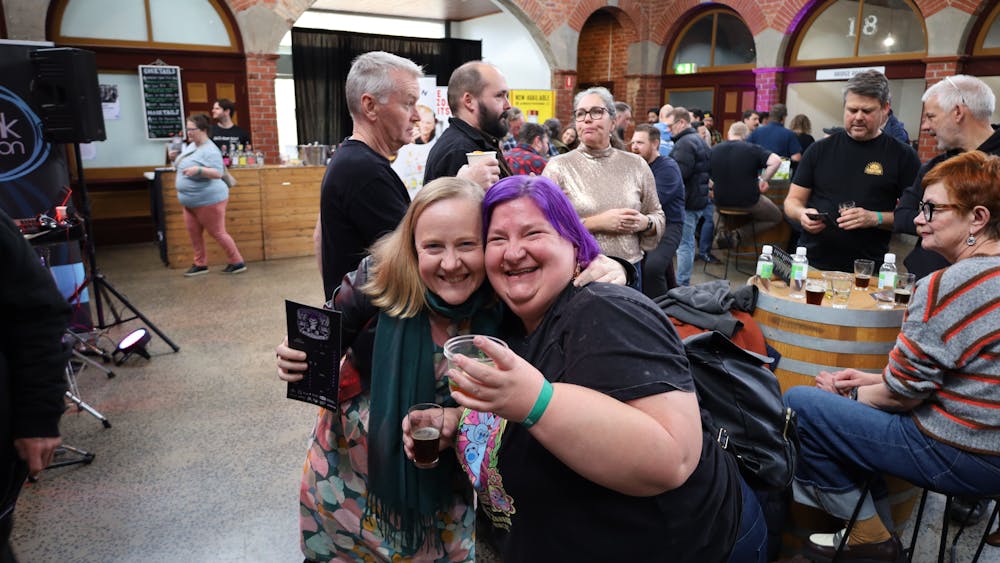 Two festival attendees smiling for the camera