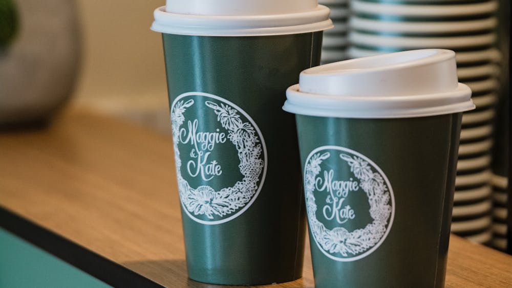 Take away coffee cups, branded Maggie & Kate containing Allpress coffee