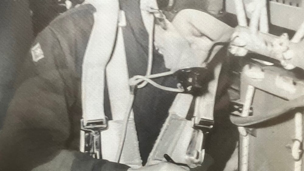 Airmen in an aircraft recoding message by Morse Code