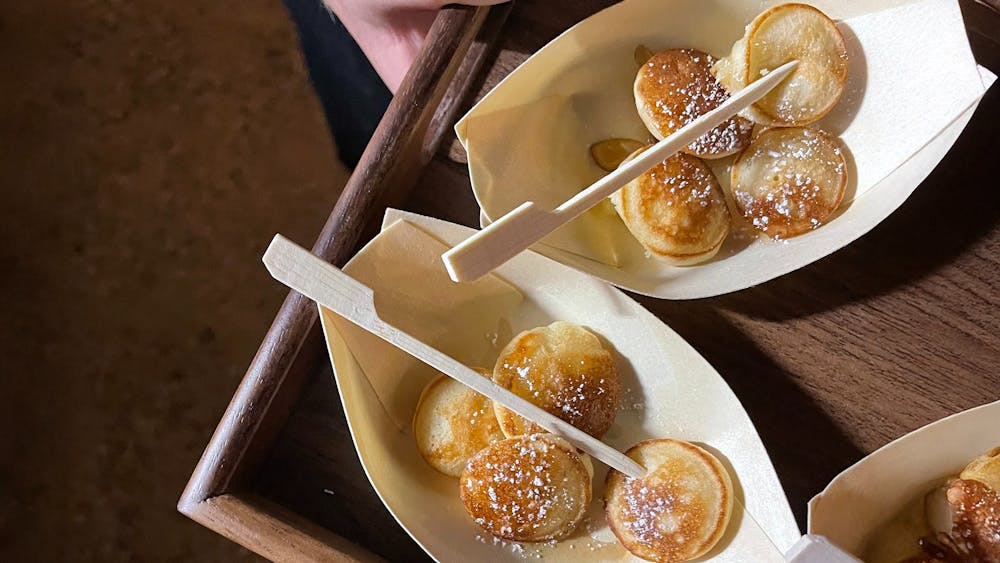 Mini pancakes in plates with picks in them