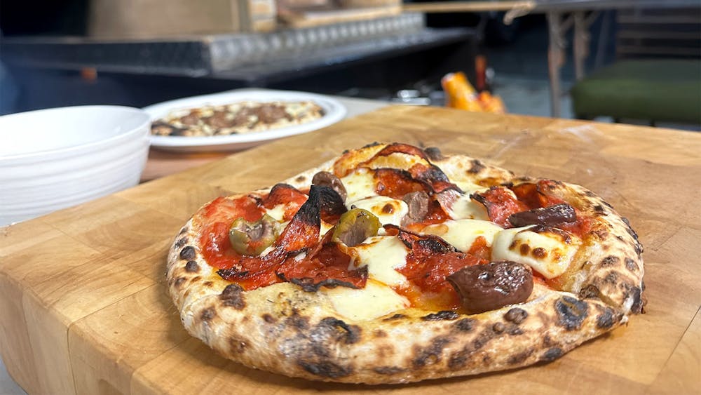 Woordfire oven Pizza on a wooden board