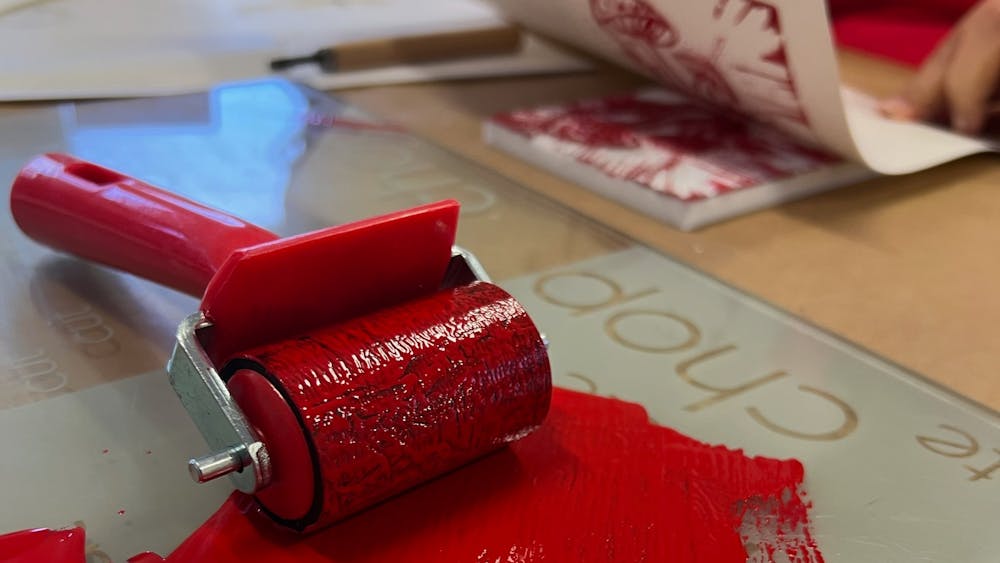 A roller and red ink on glass