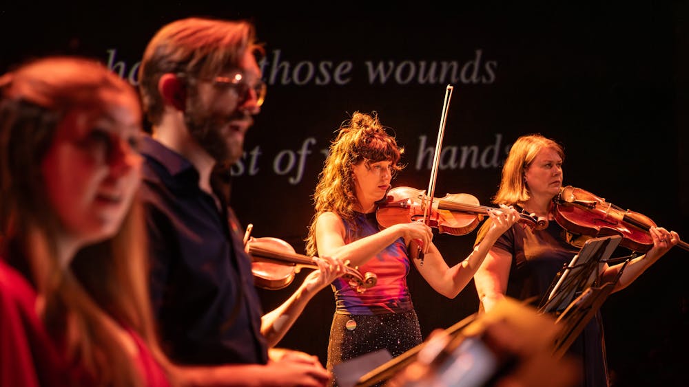 Singers and string players performing