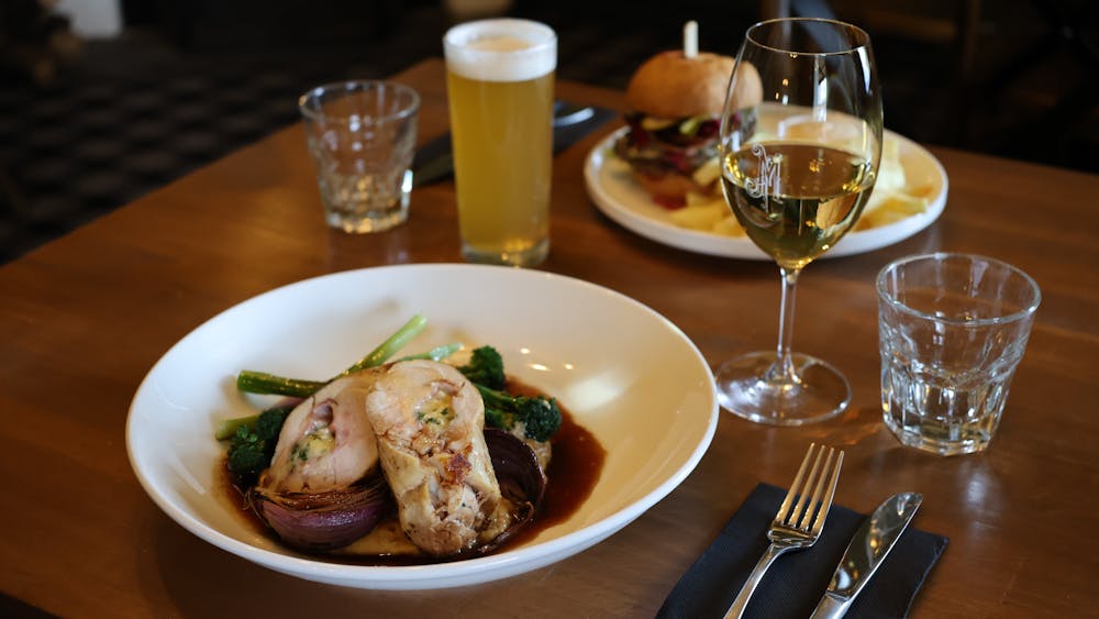 Stuffed Chicken Leg and Burger with a glass of wine and beer on the table