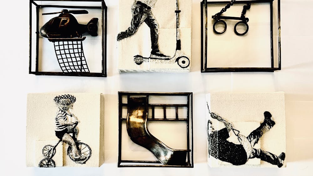 Squares with drawings, prints and 3D sculptures on them