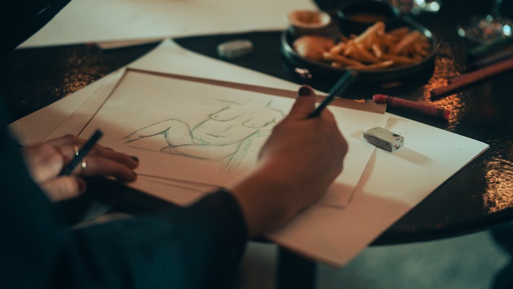 Drawing with hand holding pencil