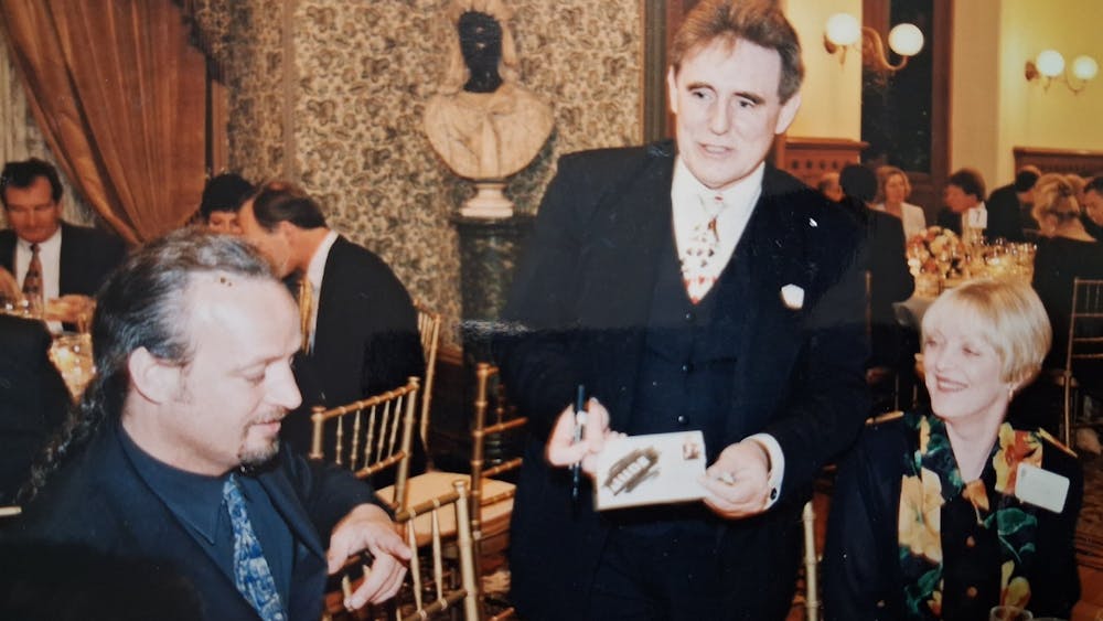 vintage images of Barry performing slight of hand at the dinnner table