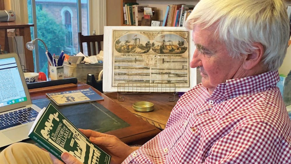 portrait of the speaker in his office reading a book