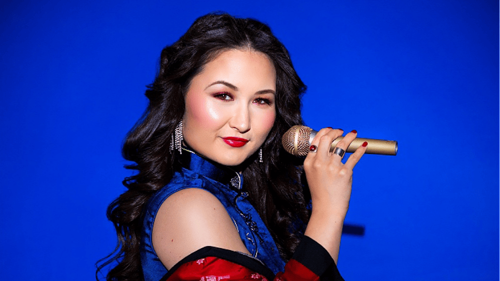 Portrait of artist with mic on a deep blue background