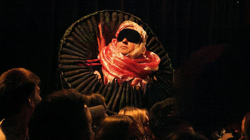 Artist in red and pink costume