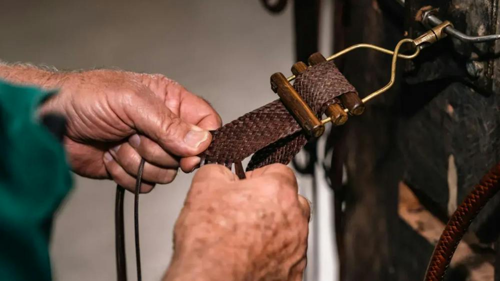 Pair of hands plaiting leather belt