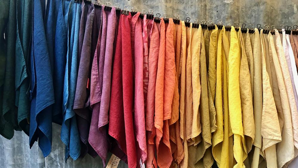 Colourful fabrics hanging on rod