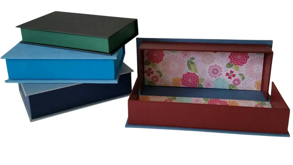 Four cloth covered boxes