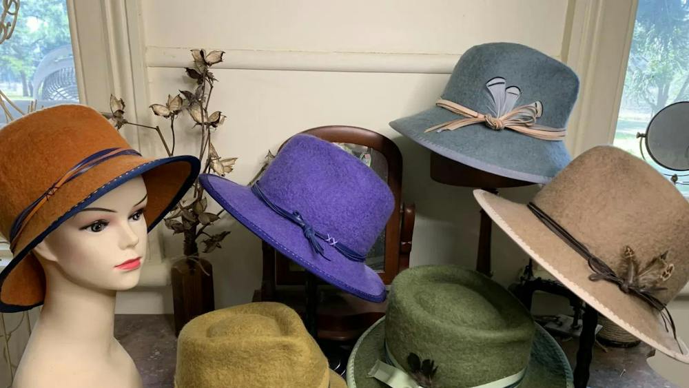 Six felt hats displayed on mannequin heads